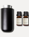 A sleek matte black waterless nebulizing diffuser presented alongside two 10ml bottles of Vaucluse Peppermint Essential Oil.