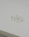 Close-up macro view highlighting the rich textured cotton paper and fine gold metallic lettering on the Vaucluse luxury romantic greeting card.