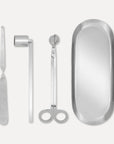 Premium silver candle care accessory set featuring a stainless steel wick trimmer, candle snuffer, wick dipper, and matching oval tray on a clean background.
