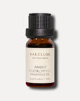 A front-facing studio product shot of a 10ml amber glass bottle of Vaucluse Amber Eucalyptus Essential Oil with a black cap, casting a soft shadow.