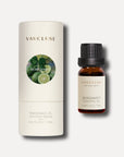 A 10ml amber bottle of Vaucluse bergamot essential oil standing beside its white cylindrical protective packaging tube.