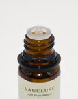 Close-up view of the glass amber bottle top and built-in dropper cap for Vaucluse essential oil.
