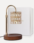 Vaucluse Fragrance luxury crystal candle warmer lamp featuring a beige tinted glass shade, curved gold arm, and a round wooden base next to its premium white gift box.