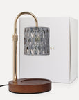 Vaucluse Fragrance luxury smoky grey crystal candle warmer lamp with a charcoal-tinted glass shade, curved gold neck, and wood base beside its white product box.