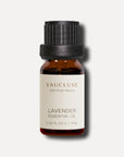 A minimalist e-commerce studio shot of a 10ml amber glass bottle of Vaucluse Lavender Essential Oil with a black ribbed cap.