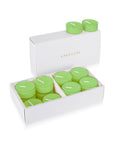 An open luxury white Vaucluse box set displaying premium light green lily scented tealight candles arranged in a tiered 16-pack tray.