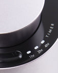 A close-up shot of the touch-sensitive black glass control interface on the purple dusk diffuser highlighting the 1hr, 2hr, and 4hr timer indicators.