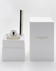 A close-up of the premium white Vaucluse gift box opened to reveal the secure, tailored interior compartment holding the glass diffuser bottle and its custom reed cap.