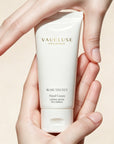 Hands gently framing a tube of Vaucluse Fragrance Rose Velvet luxury hand lotion.