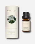 A 10ml bottle of Vaucluse tuberose essential oil positioned alongside its white cylindrical container packaging box.