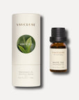 A 10ml bottle of white tea essential oil standing beside its white cylindrical tube box which displays a circular green leaf motif.