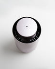 A high-angle top-down view of the circular purple dusk waterless diffuser showcasing the central mist output nozzle and clean touch controls.