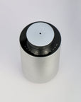 An overhead top-down perspective of the circular silver waterless diffuser, showing the central scent mist nozzle and touch control panel layout.