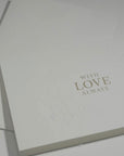 Side angle close-up emphasizing the clean typography and premium blind-embossed floral framework on a luxury love and anniversary greeting card.
