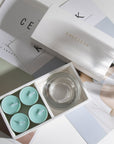 Aesthetic top-down view of the premium ocean scented tealight candle gift set laid out across white minimalist magazines.