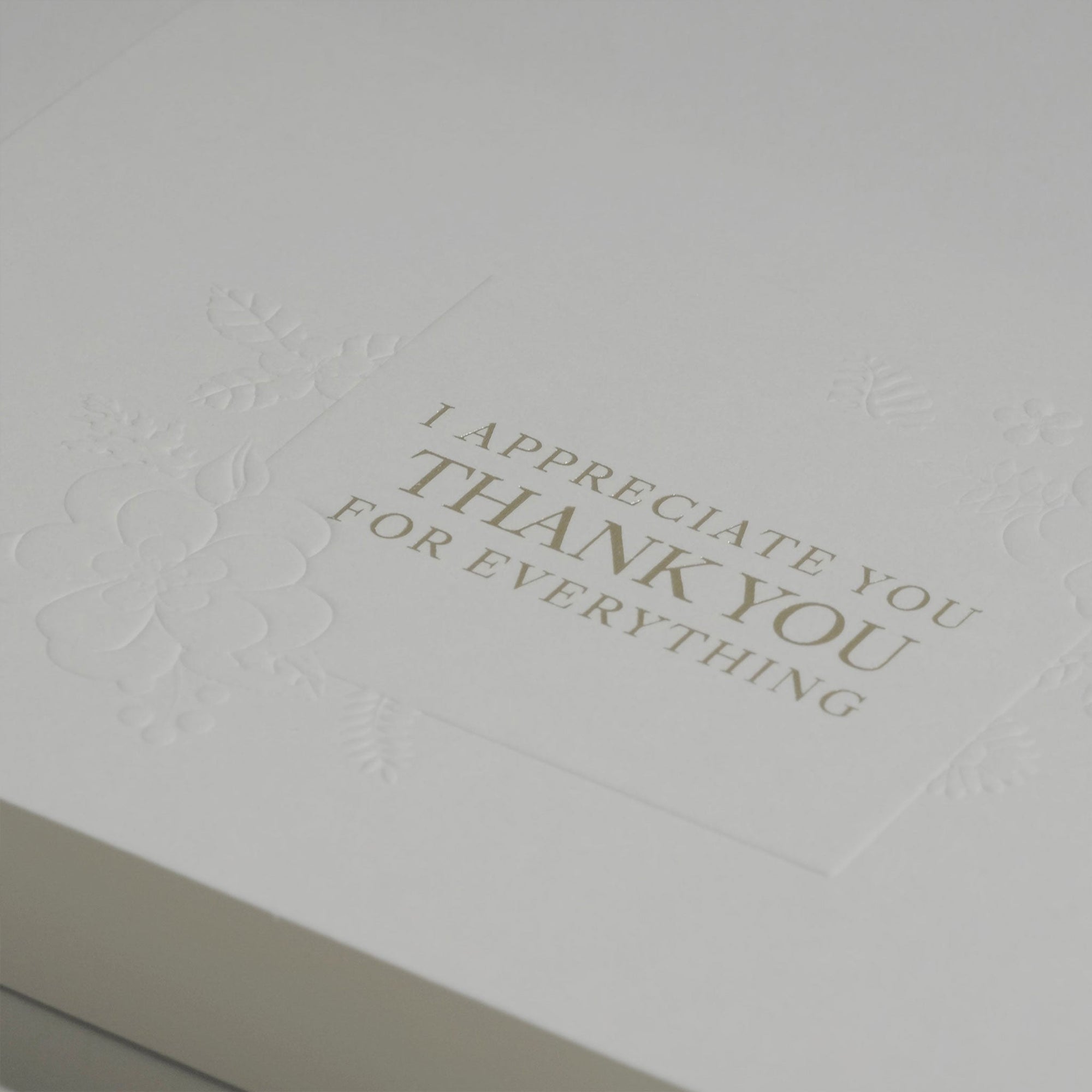Close-up macro shot showcasing the high-quality textured cardstock and fine debossed details of the Vaucluse appreciation note.