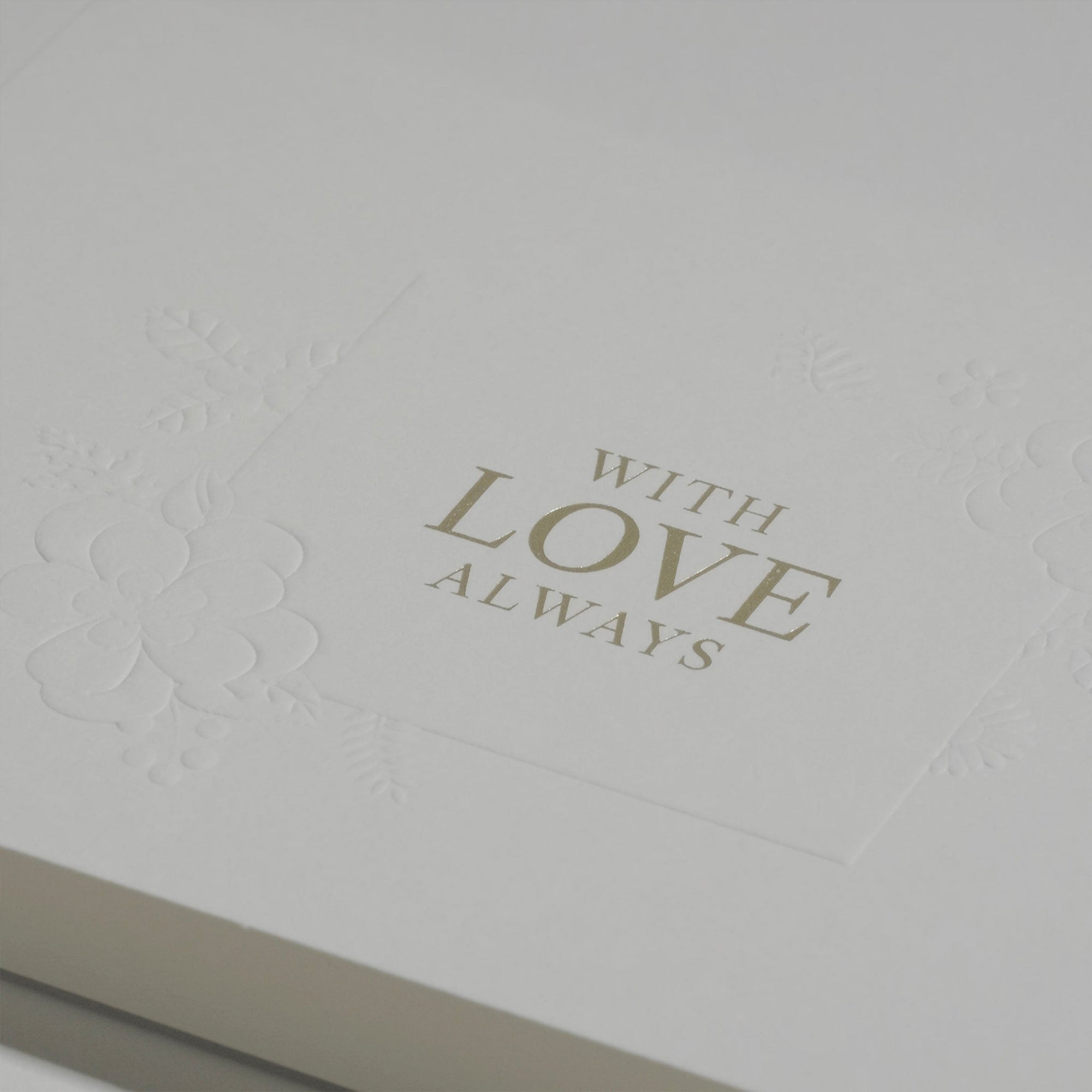 Close-up macro view highlighting the rich textured cotton paper and fine gold metallic lettering on the Vaucluse luxury romantic greeting card.