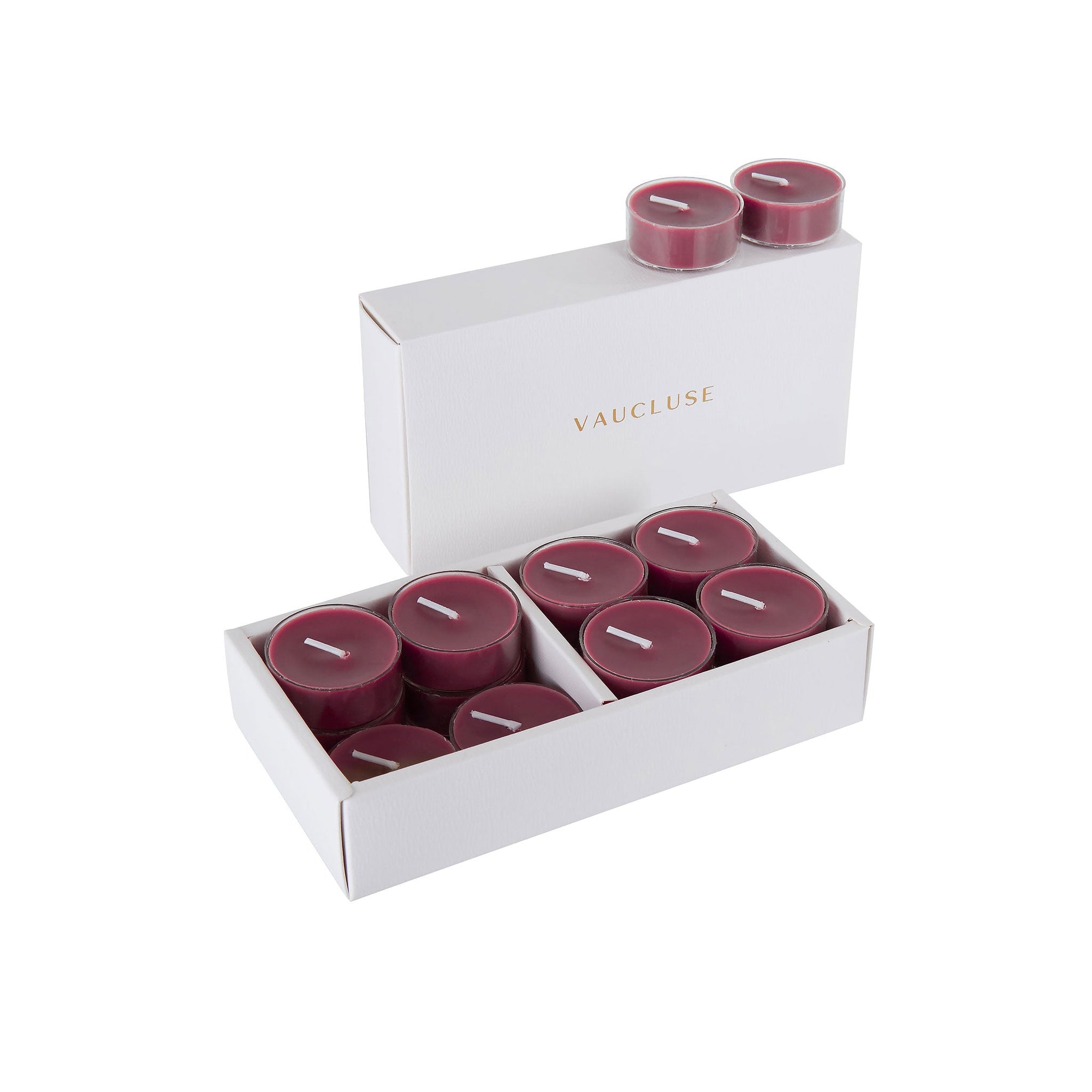An open luxury white Vaucluse box set displaying premium deep purple blackberry scented tealight candles arranged in a tiered 16-pack tray.