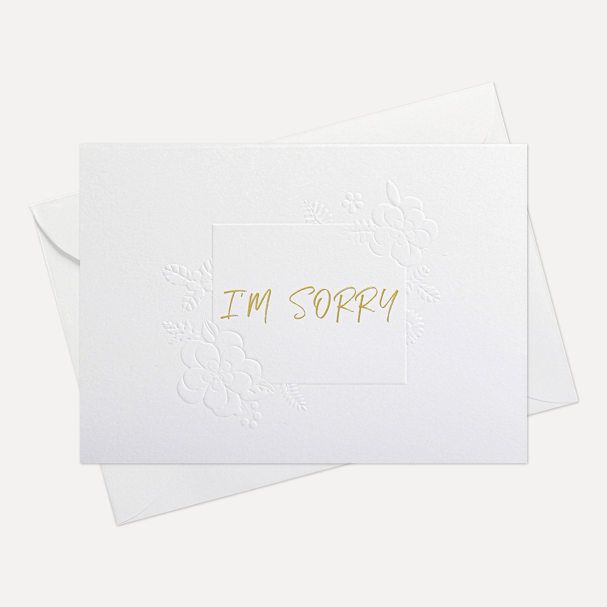 Front view of a minimalist white Vaucluse "I'm Sorry" apology greeting card resting on its matching white paper envelope.