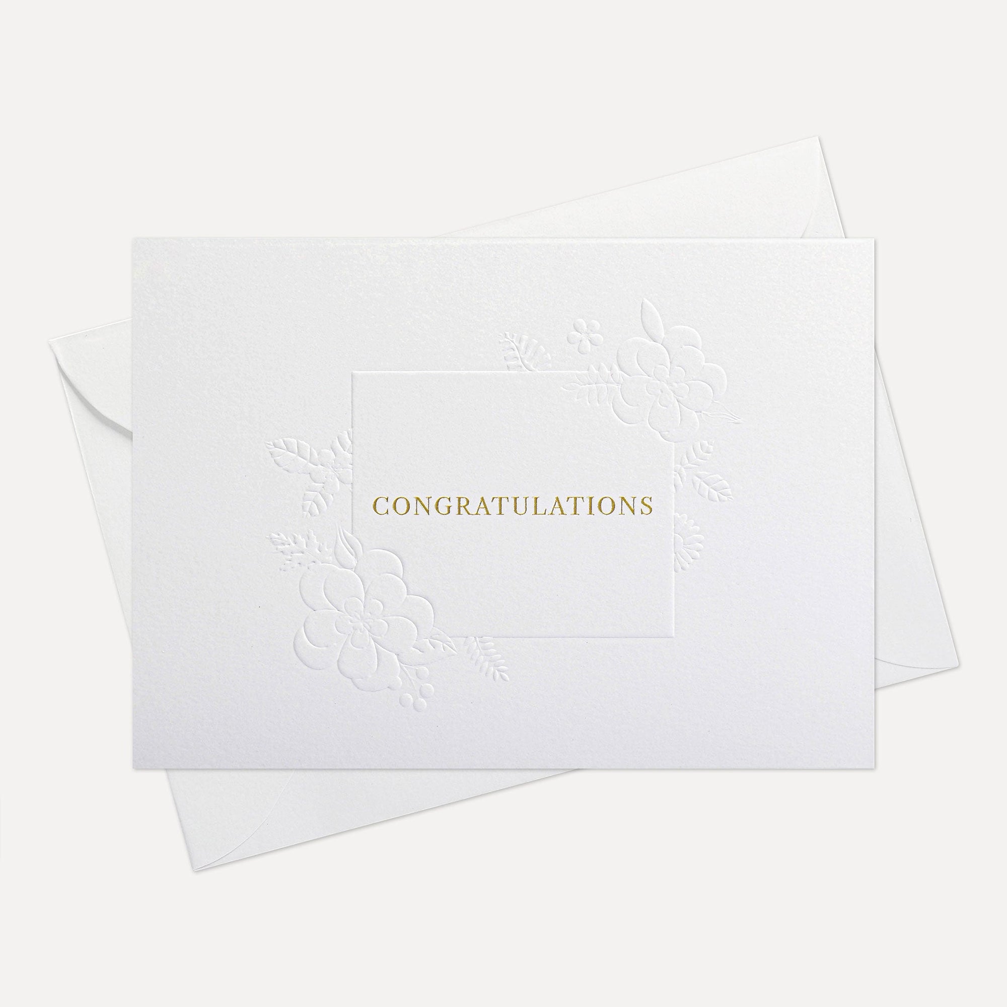 Front view of a minimalist luxury white congratulations card featuring elegant gold text and a blind-embossed floral border framework, displayed with its matching envelope.