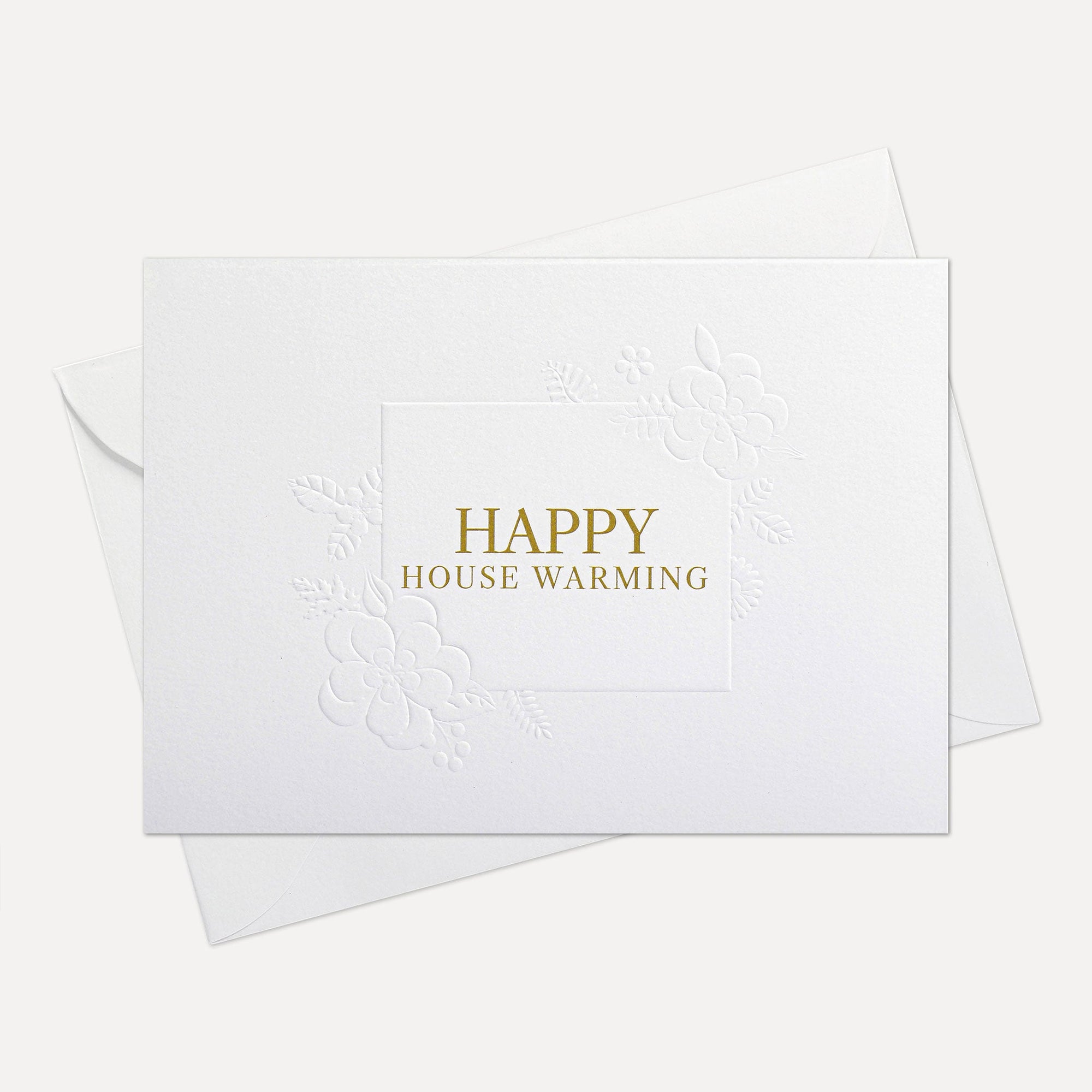 Front flat lay view of a minimalist luxury white housewarming card featuring elegant gold text reading Happy House Warming, displayed with its matching white envelope.