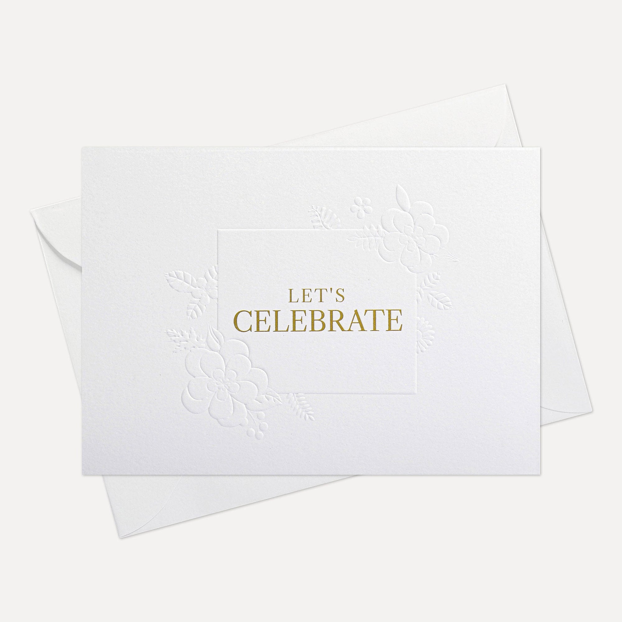 Front flat lay view of a minimalist luxury white celebration card featuring elegant gold text reading Let's Celebrate, displayed with its matching white envelope.