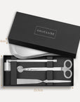Vaucluse Fragrance luxury black gift box packaging revealing a silver candle trimmer tool set with labeled dimensions.