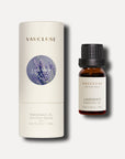 A 10ml amber bottle of Vaucluse lavender essential oil standing beside its white cylindrical protective packaging tube.