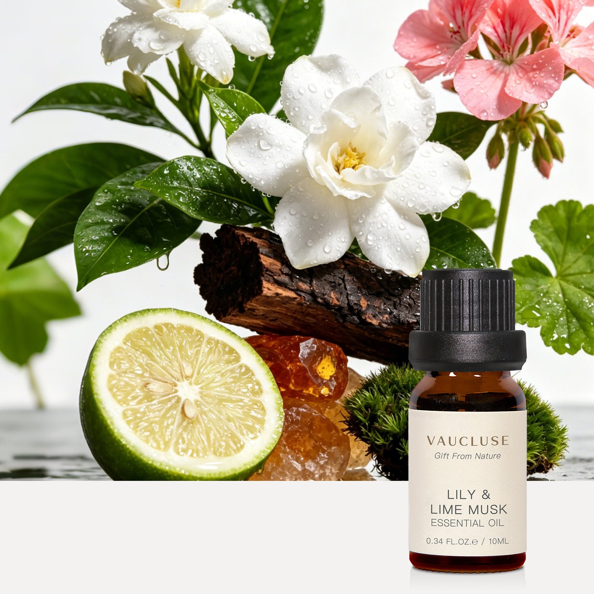 Vaucluse Lily and Lime Musk essential oil bottle styled with white gardenia flowers, sliced fresh lime, geranium, and bark.