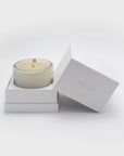 Premium unboxing experience showing a Vaucluse soy wax candle sitting inside its custom two-piece white luxury gift box container.