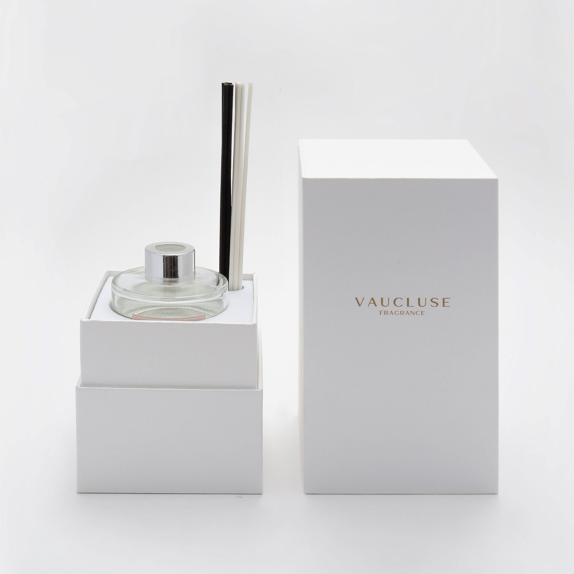 A close-up of the opened white Vaucluse gift box revealing the tailored interior compartments designed to securely hold the clear glass diffuser bottle and reed assembly.