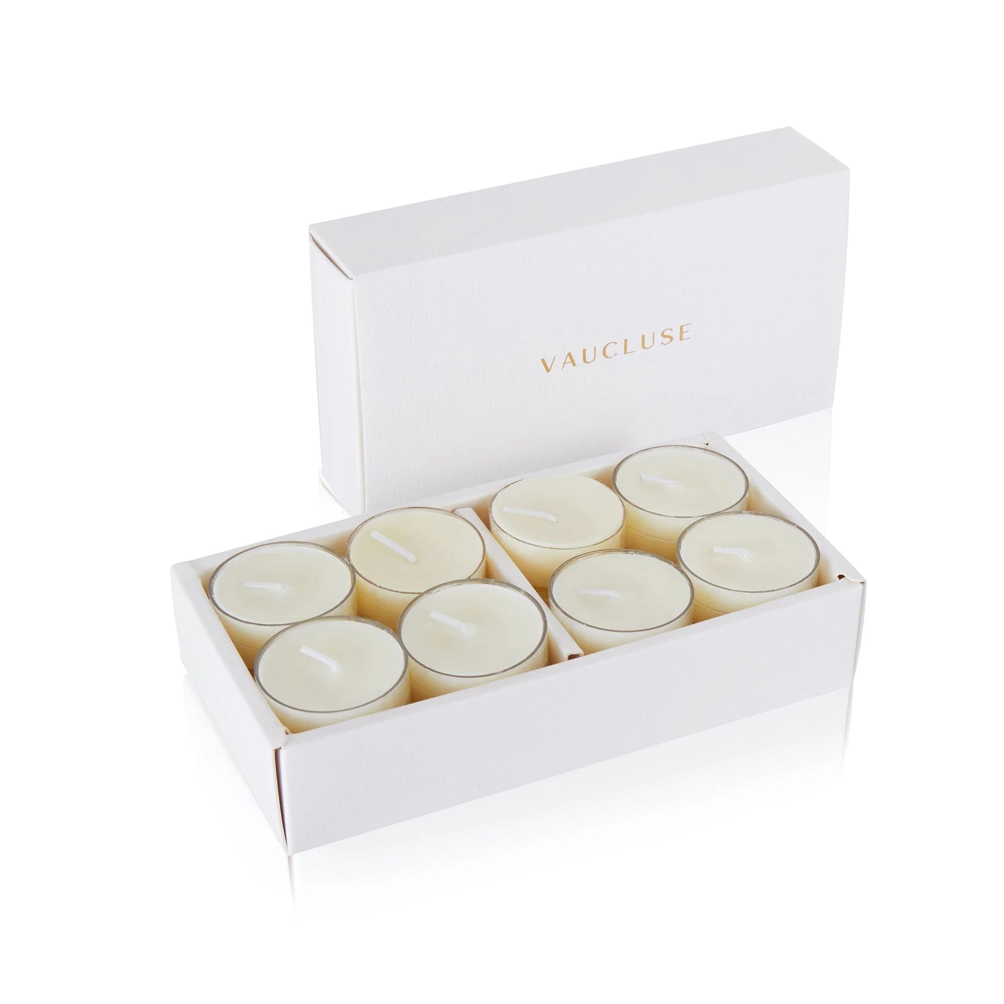An open luxury white Vaucluse box set displaying premium cream white musk scented tealight candles arranged in a tiered 16-pack tray.