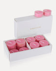 An open luxury white Vaucluse box displaying a full set of pink rose scented tealight candles.