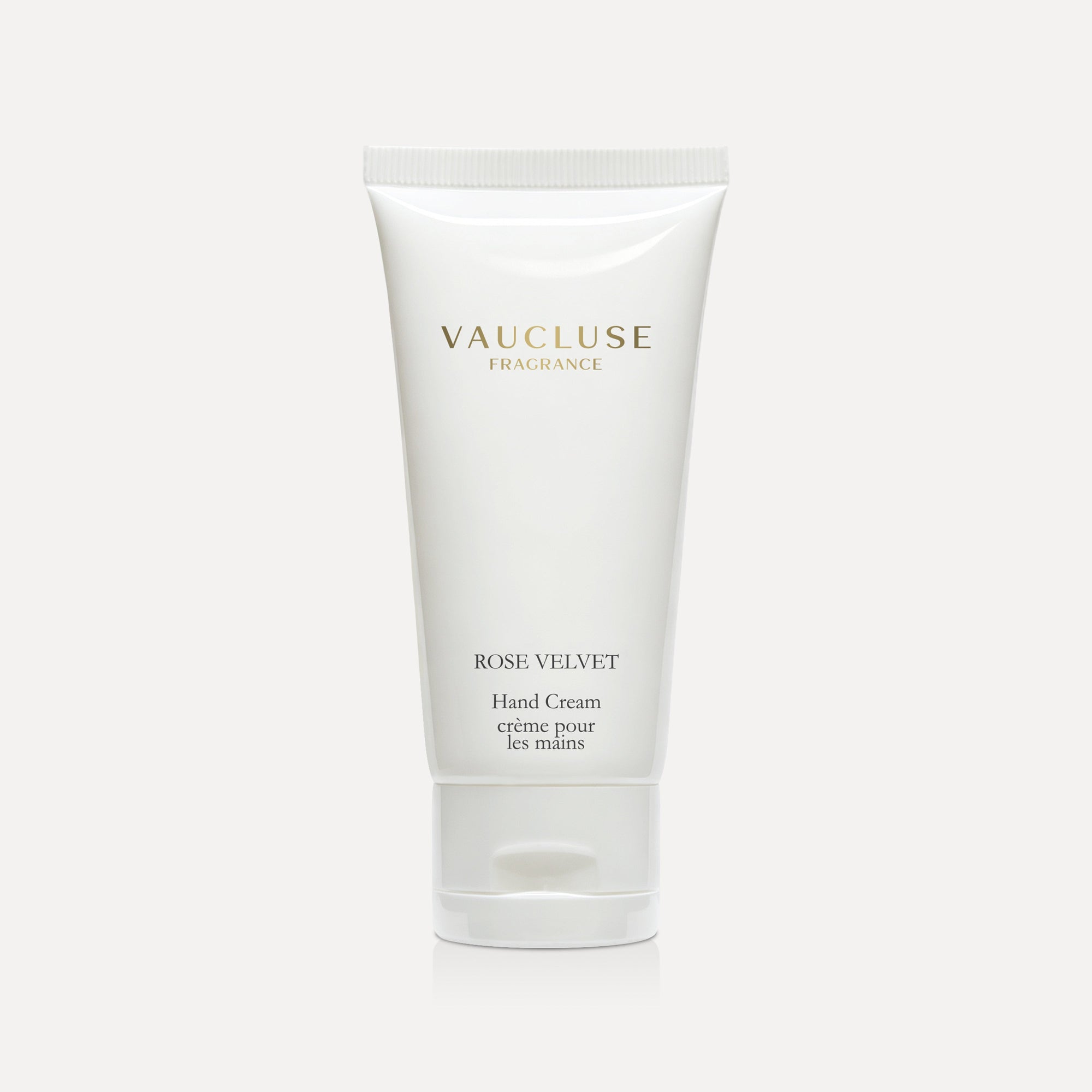Vaucluse Fragrance Rose Velvet Hand Cream in a sleek white tube against a minimal grey studio background.