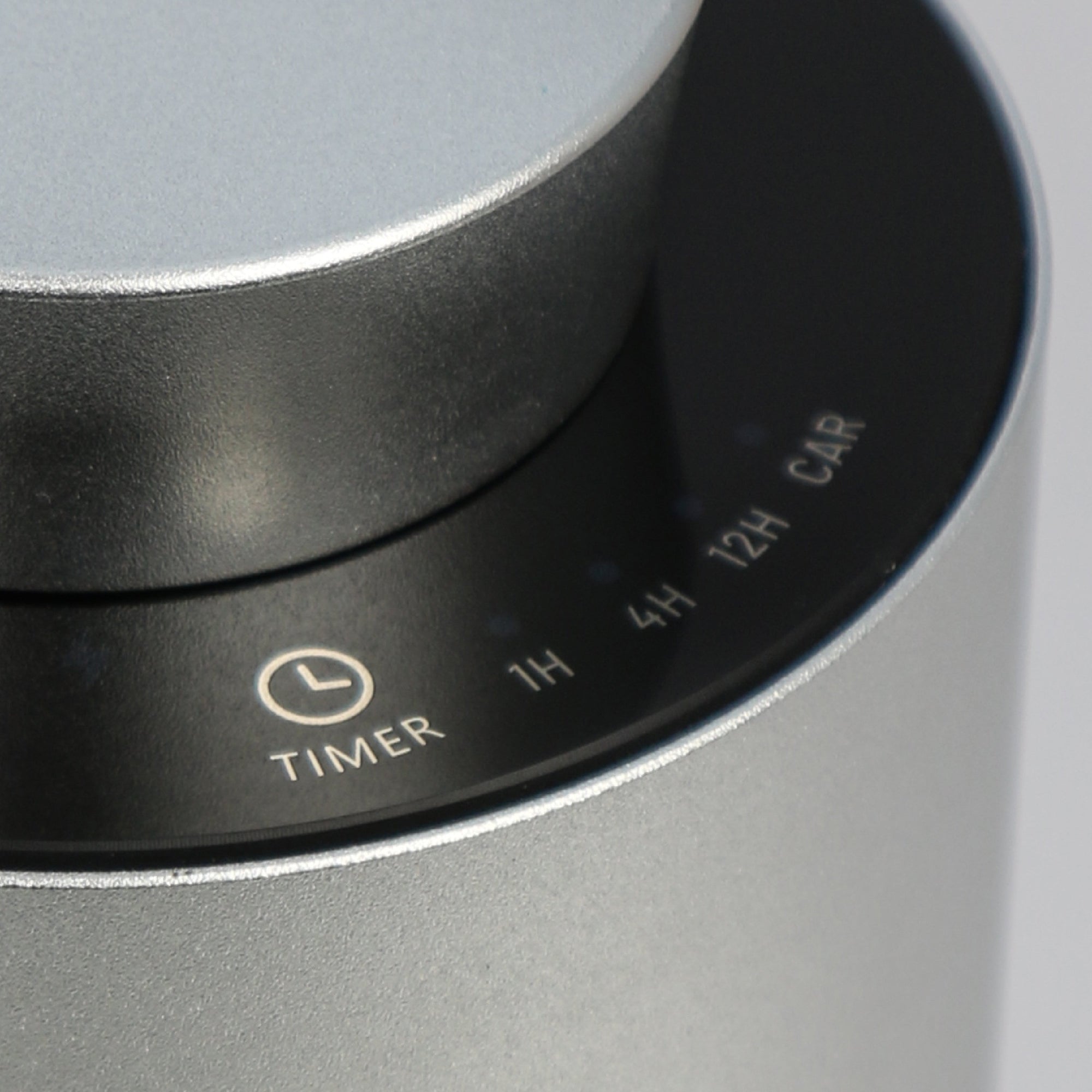 A close-up shot of the touch-sensitive control panel on the silver diffuser, showing the custom timer intervals for 1H, 4H, 12H, and Car mode.