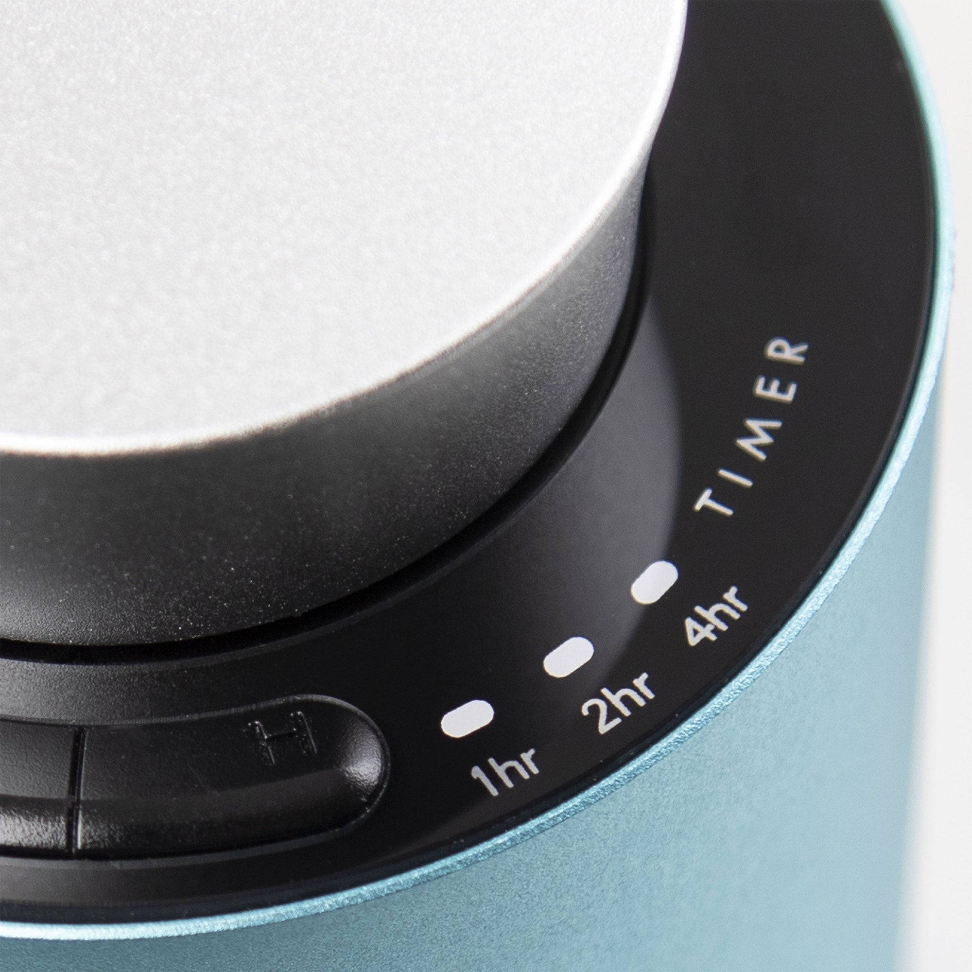 A detailed close-up of the black glass touch control panel on the teal diffuser showing integrated timer settings for 1hr, 2hr, and 4hr modes.