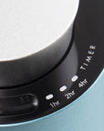 A detailed close-up of the black glass touch control panel on the teal diffuser showing integrated timer settings for 1hr, 2hr, and 4hr modes.