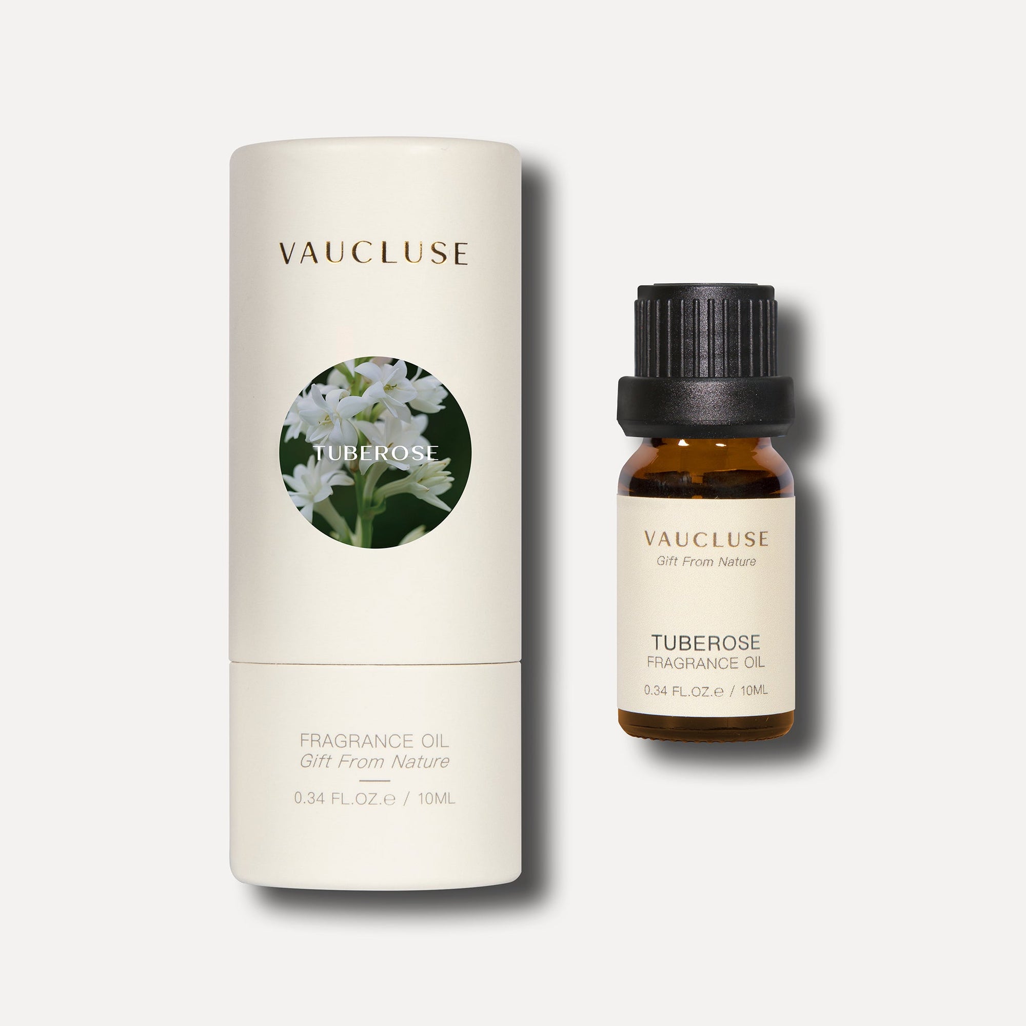 A 10ml bottle of Vaucluse tuberose essential oil positioned alongside its white cylindrical container packaging box.