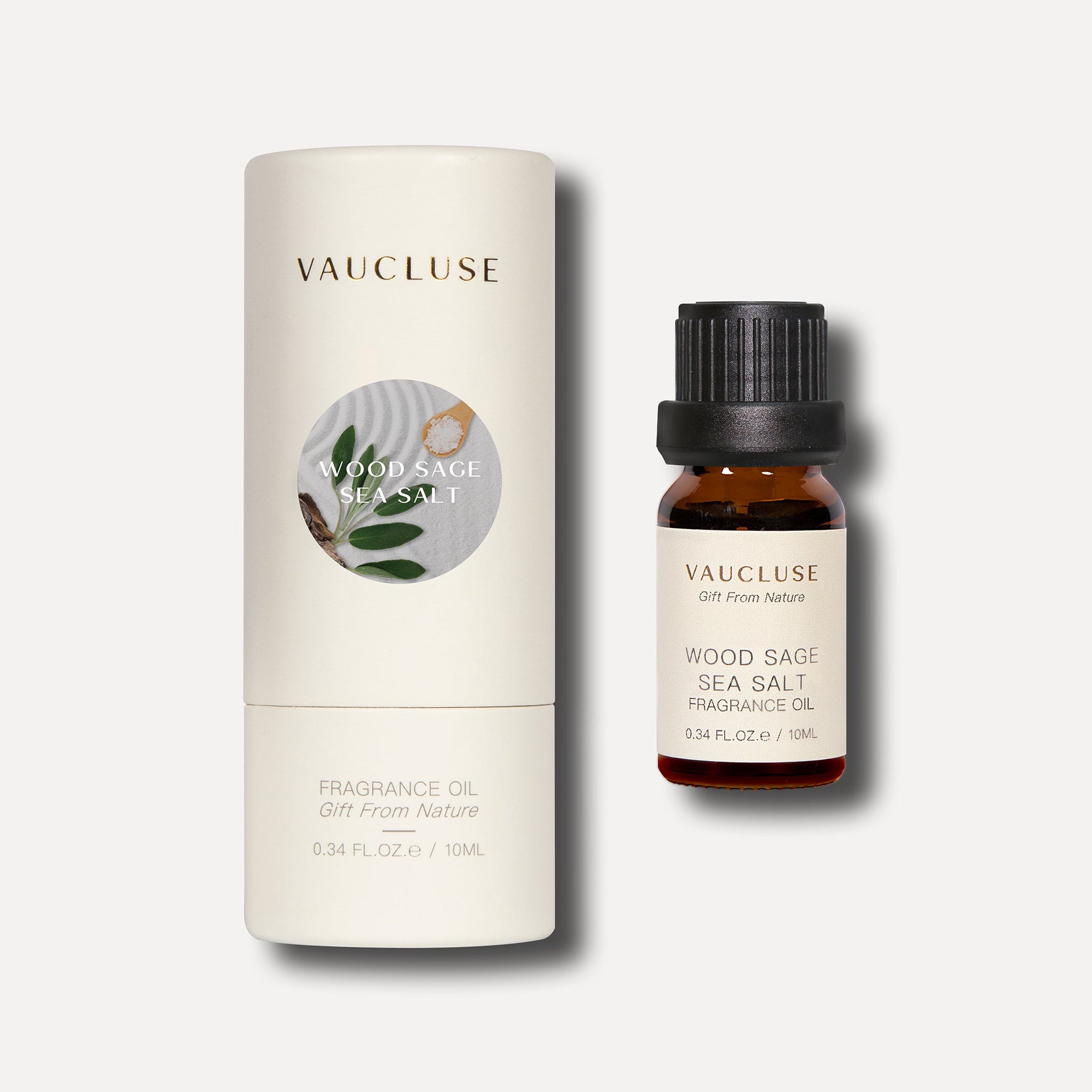 A 10ml bottle of Vaucluse wood sage and sea salt essential oil standing beside its white cardboard cylindrical container packaging.